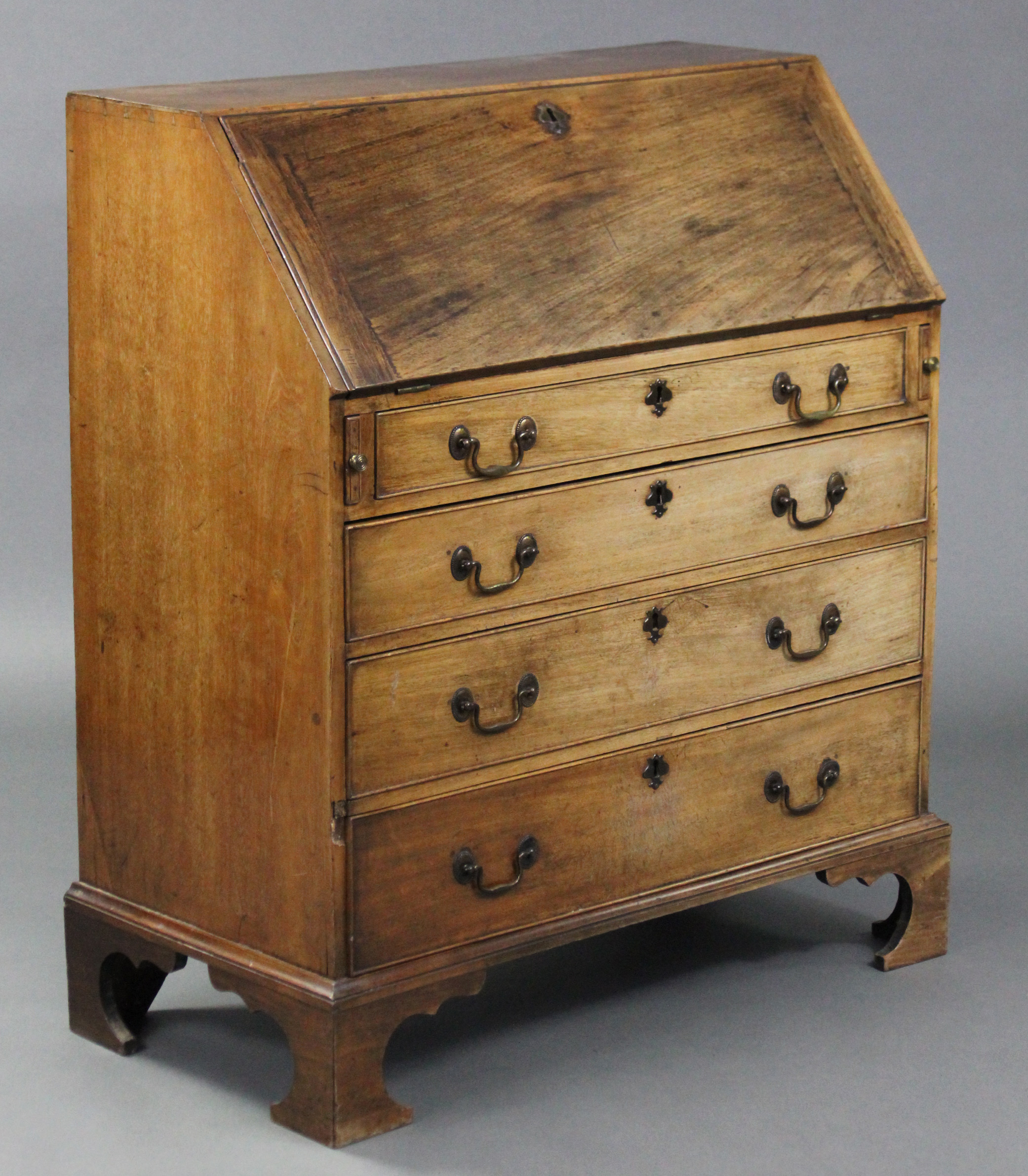 A late 18th century mahogany bureau, the sloping fall-front enclosing a fitted interior above four