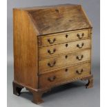 A late 18th century mahogany bureau, the sloping fall-front enclosing a fitted interior above four