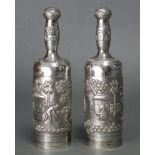 A pair of Indian silver cylindrical bottles with screw caps & interior stoppers to the narrow necks,