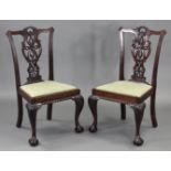 A pair of Chippendale style mahogany dining chairs with carved & pierced splat backs, padded drop-in