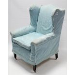 A late 19th/early 20th century wing-back upholstered armchair, on short square tapered legs with