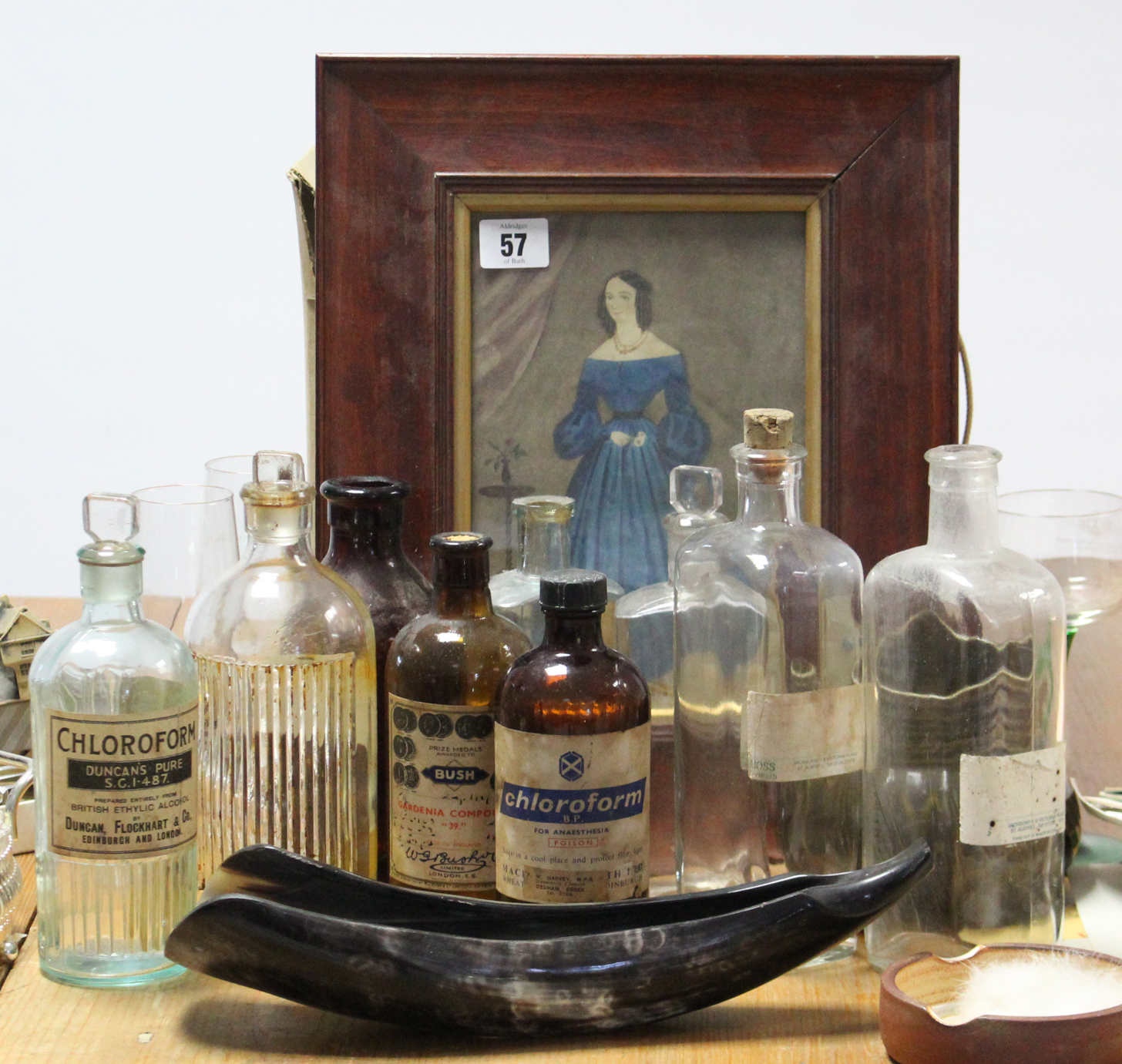 A collection of approximately thirty various apothecary bottles; a full-length female portrait;