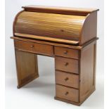 A pine cylinder-top desk, with fitted interior enclosed by tambour shutter, & fitted with an