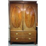 A 19th century inlaid-mahogany wardrobe (converted from a linen press) enclosed by pair of oval