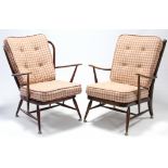 A near pair of Ercol spindle-back armchairs, each with loose cushion to the seat & back, & on