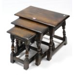 An oak nest of three rectangular occasional tables, each table on four baluster-turned legs with