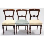 Three Victorian balloon-back dining chairs, each with sprung seat, & on turned tapered legs.