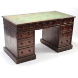 A Victorian mahogany pedestal desk, inset gilt tooled leather top, fitted with an arrangement of