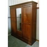 A late Victorian mahogany small triple-door wardrobe with moulded cornice, having fitted interior