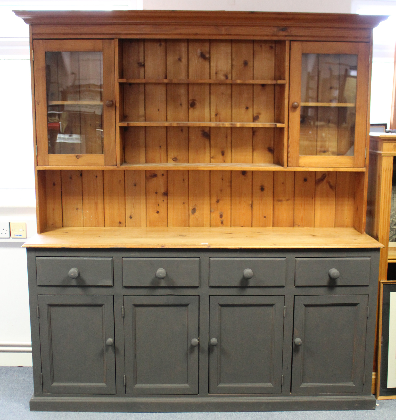 A natural & grey painted pine dresser, the upper part fitted three open shelves to the centre