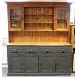 A natural & grey painted pine dresser, the upper part fitted three open shelves to the centre