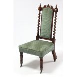 A Victorian mahogany prie-dieu chair with padded back & sprung seat, & on short turned legs with