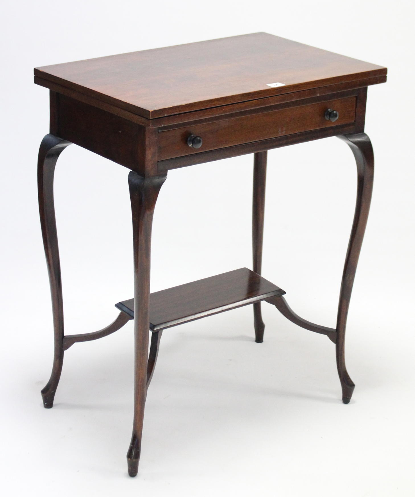 An Edwardian mahogany card table inset green baize to the rectangular fold-over top, fitted frieze