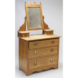 A late Victorian walnut dressing chest with rectangular swing mirror to the stage back, fitted three
