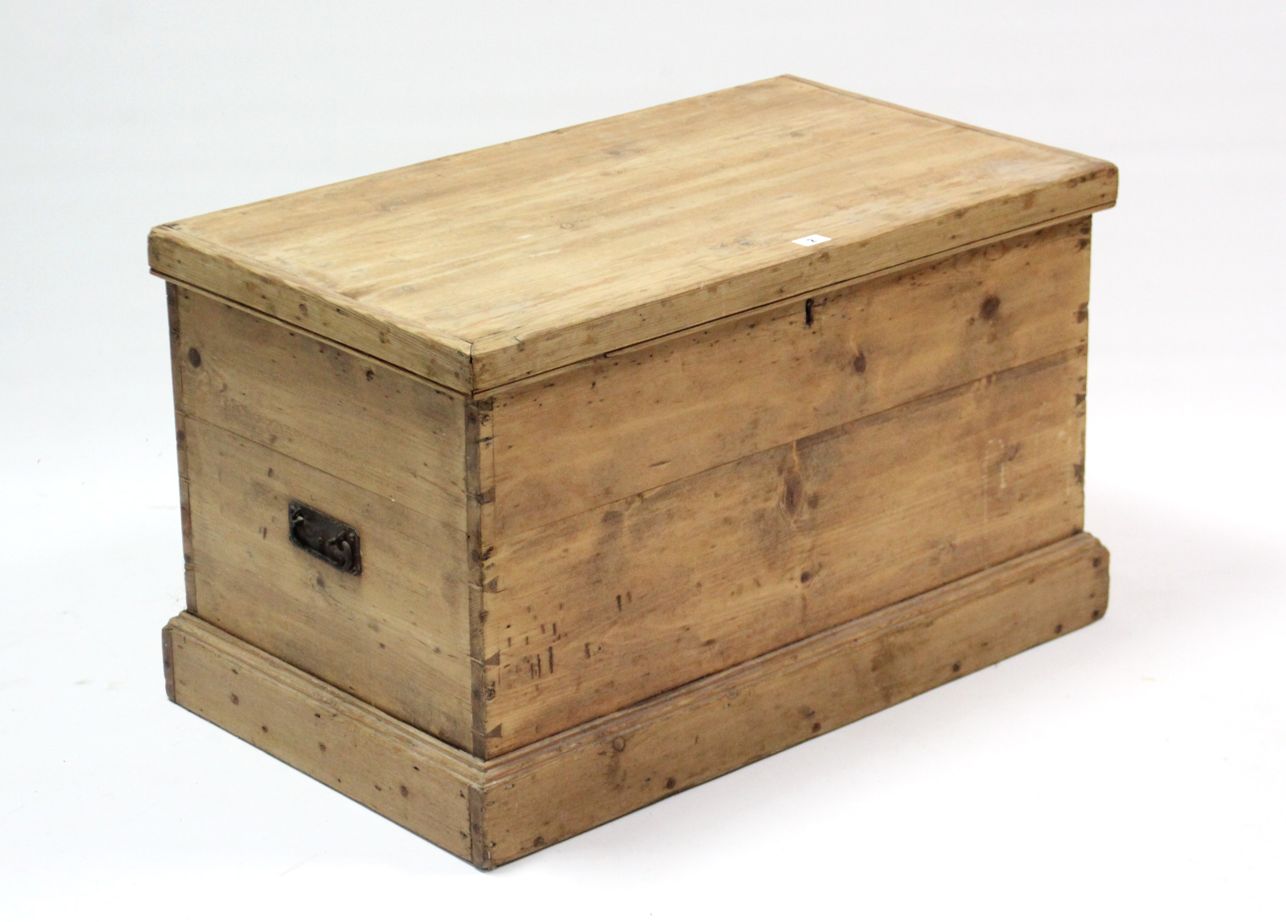 A pine blanket box, with hinged lift-lid, wrought iron side handles, & on plinth base, 32¼” wide x