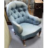A late Victorian buttoned-back armchair (requires reupholstering), on short ring-turned legs with