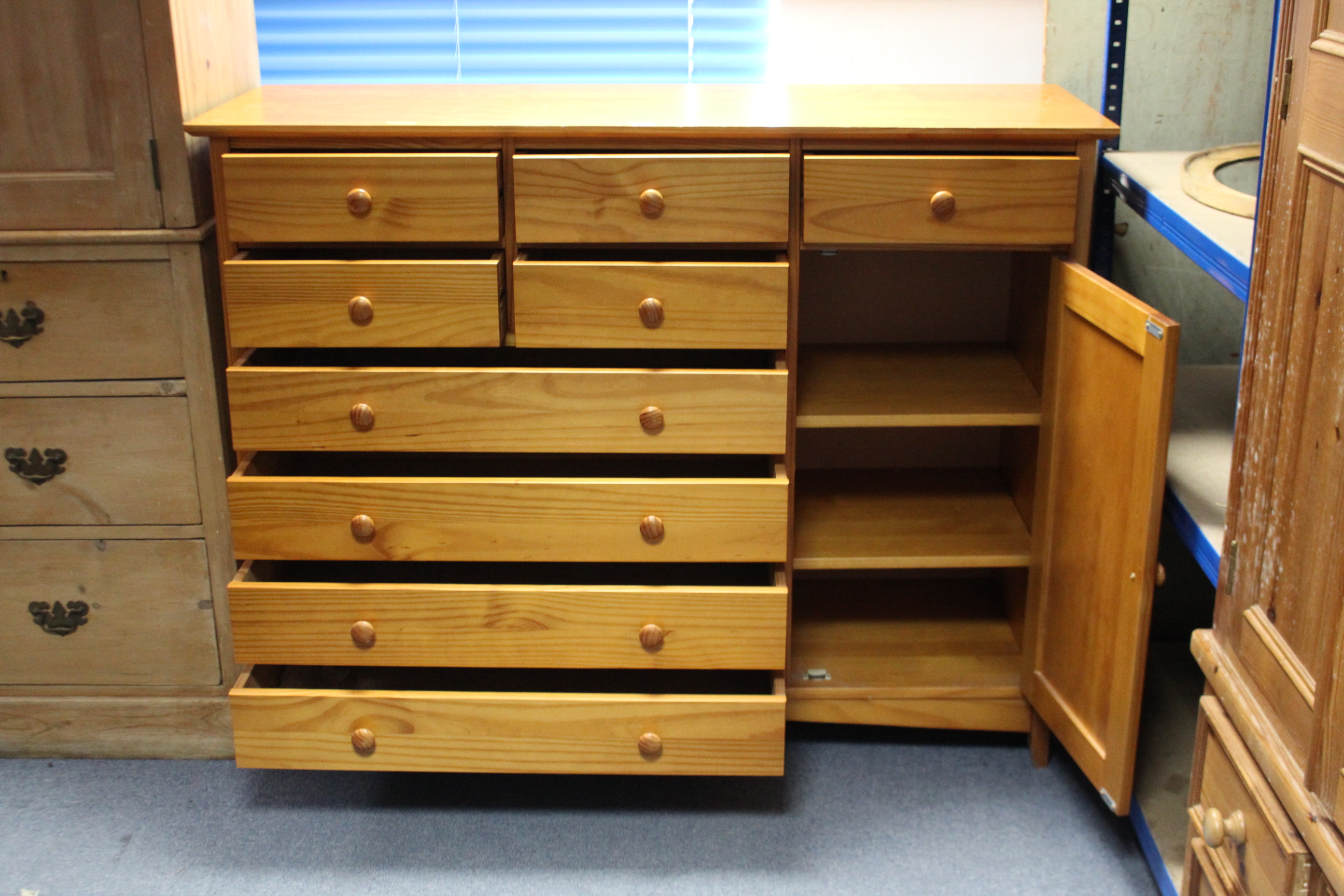 A modern pine combination chest/cupboard, fitted with an arrangement of nine drawers & enclosed by a - Image 2 of 2