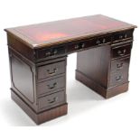 A reproduction mahogany pedestal desk-inset gilt tooled crimson leather cloth, fitted with an