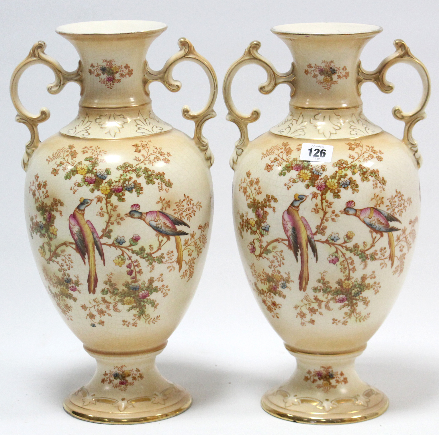 A pair of Crown Ducal ware ovoid two-handled vases of buff ground & with bright-coloured exotic bird