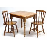 A pine kitchen table with rectangular top, & on turned tapered legs, 36” wide; & a pair of spindle-