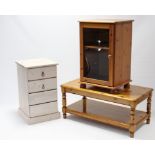 A pine four drawer bedside chest; together with a pine rectangular two-tier coffee table; & a pine