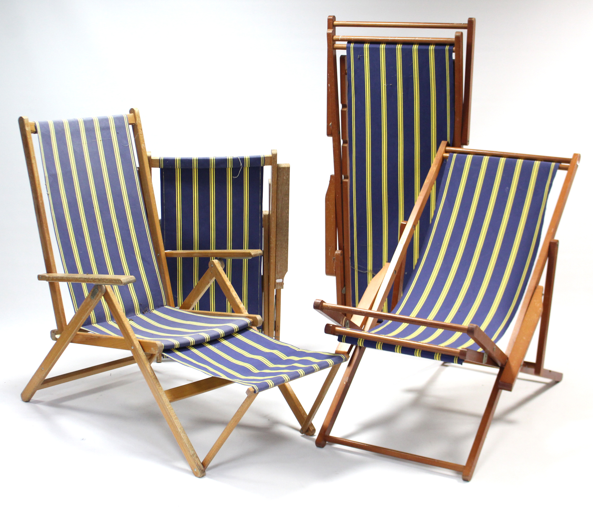Two pairs of wooden frame deckchairs.
