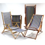 Two pairs of wooden frame deckchairs.