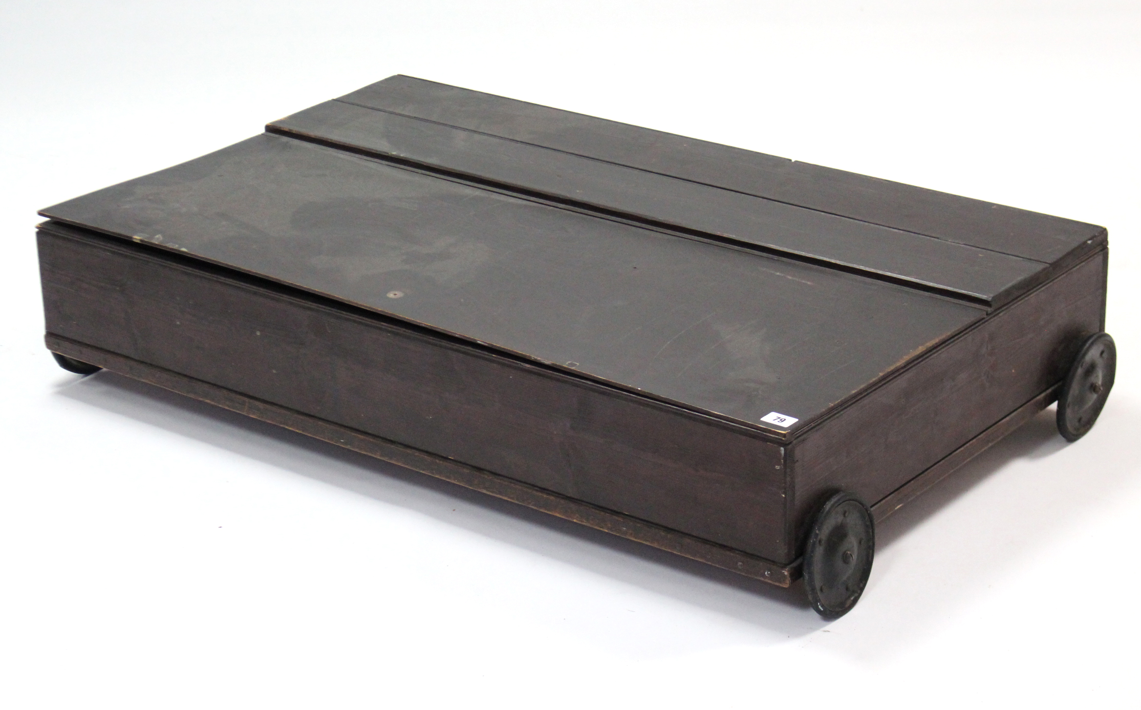 A pine under bed storage box with hinged lift-lid; & on 5” diam. wheels, 41¾” wide.