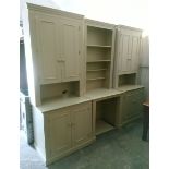 A light cream laminate tall wall unit (in three sections), fitted with an arrangement of cupboards &