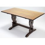An oak refectory table with rectangular top, & on pierced & shaped end supports joined by plain