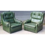 A pair of buttoned dark green leather armchairs.
