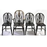 A set of four oak wheel-back dining chairs (including one carver), with hard seats & on turned