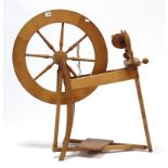 A walnut 22” diam. spinning wheel on three square tapered supports, 33” high.