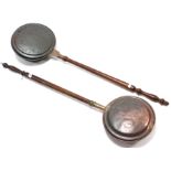 A pair of 19th century copper engraved warming pans, each with long turned wooden handle.