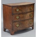 An early 19th century figured mahogany bow-front chest fitted three long graduated drawers with