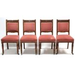 HOWARD & SONS: A set of four Victorian carved oak dining chairs with padded backs & sprung seats uph