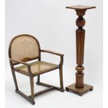 An Edwardian inlaid-mahogany tub-shaped chair with padded oval seat, & on round tapered legs with