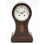 An Edwardian mantel clock with white enamel dial, striking movement, & in inlaid-mahogany balloon-