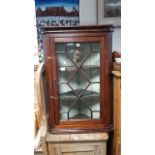 A 19th century oak hanging corner cabinet fitted two shelves enclosed by glazed door, 28½” x 40­”.