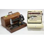 A Frister & Rossmann “Cub 7” electric sewing machine; & a Singer hand sewing machine with oak case.