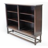 A mid-20th century oak standing open bookcase, with four adjustable shelves, & on short turned