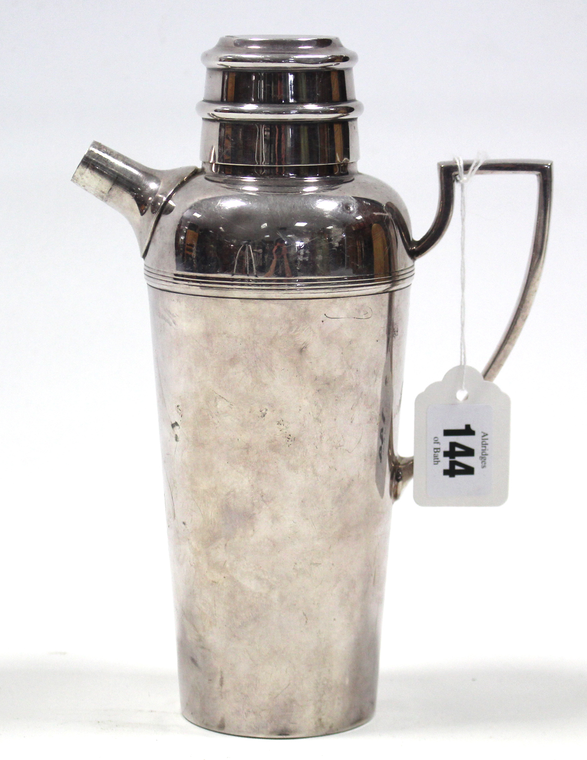 A Mappin & Webb 1¼ pint cocktail shaker with pull-off lid, short spout & angular side handle, 9”