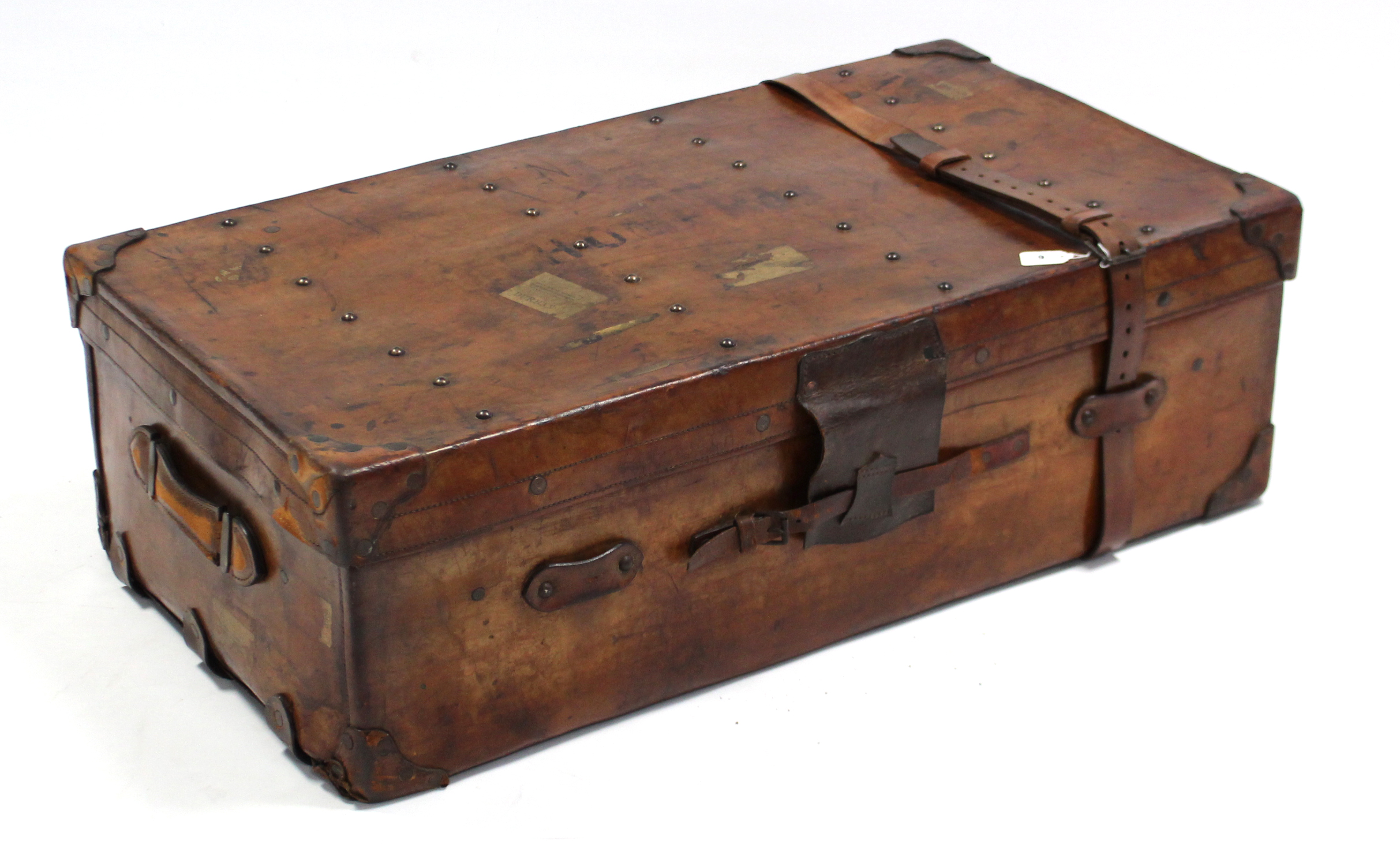 An early 20th century tan leather travelling trunk, fitted with a removable tray & bearing label “