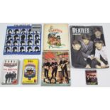 Two Beatles calendars; three volumes on “The Beatles”; & two Beatles video cassettes.