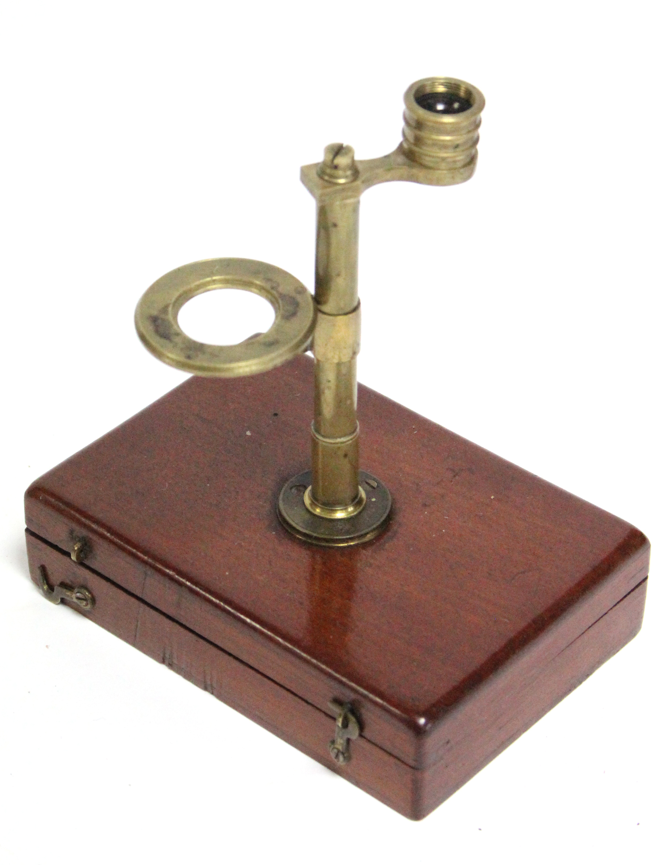 A late 19th/early 20th century brass botanist’s microscope, fitted on mahogany hinged box base,