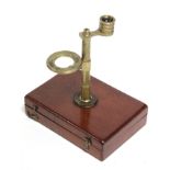 A late 19th/early 20th century brass botanist’s microscope, fitted on mahogany hinged box base,