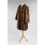 A rabbit fur silk-lined ladies’ coat; & a similar silk-lined fur cape.