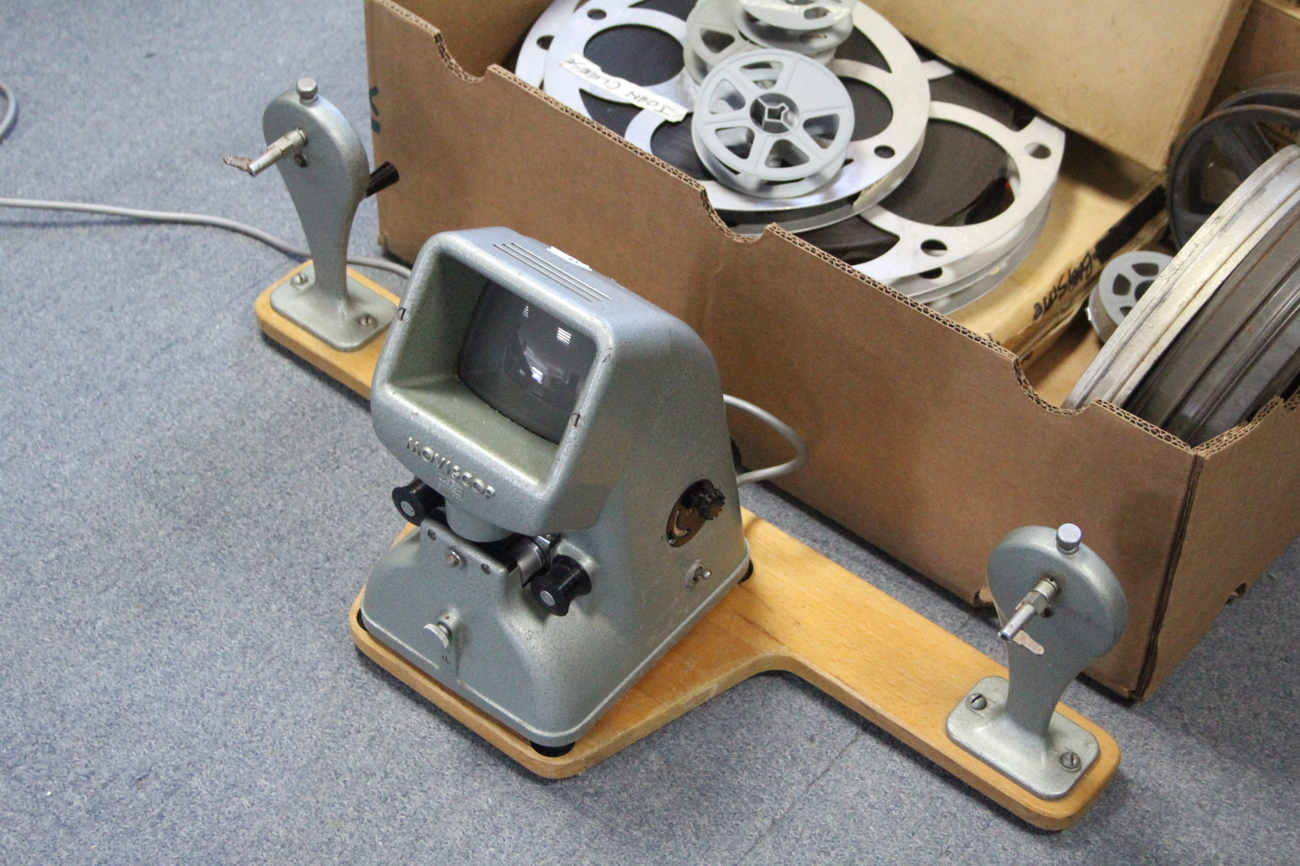 A collection of 16mm film reels; a film projector; & a film editor. - Image 11 of 11