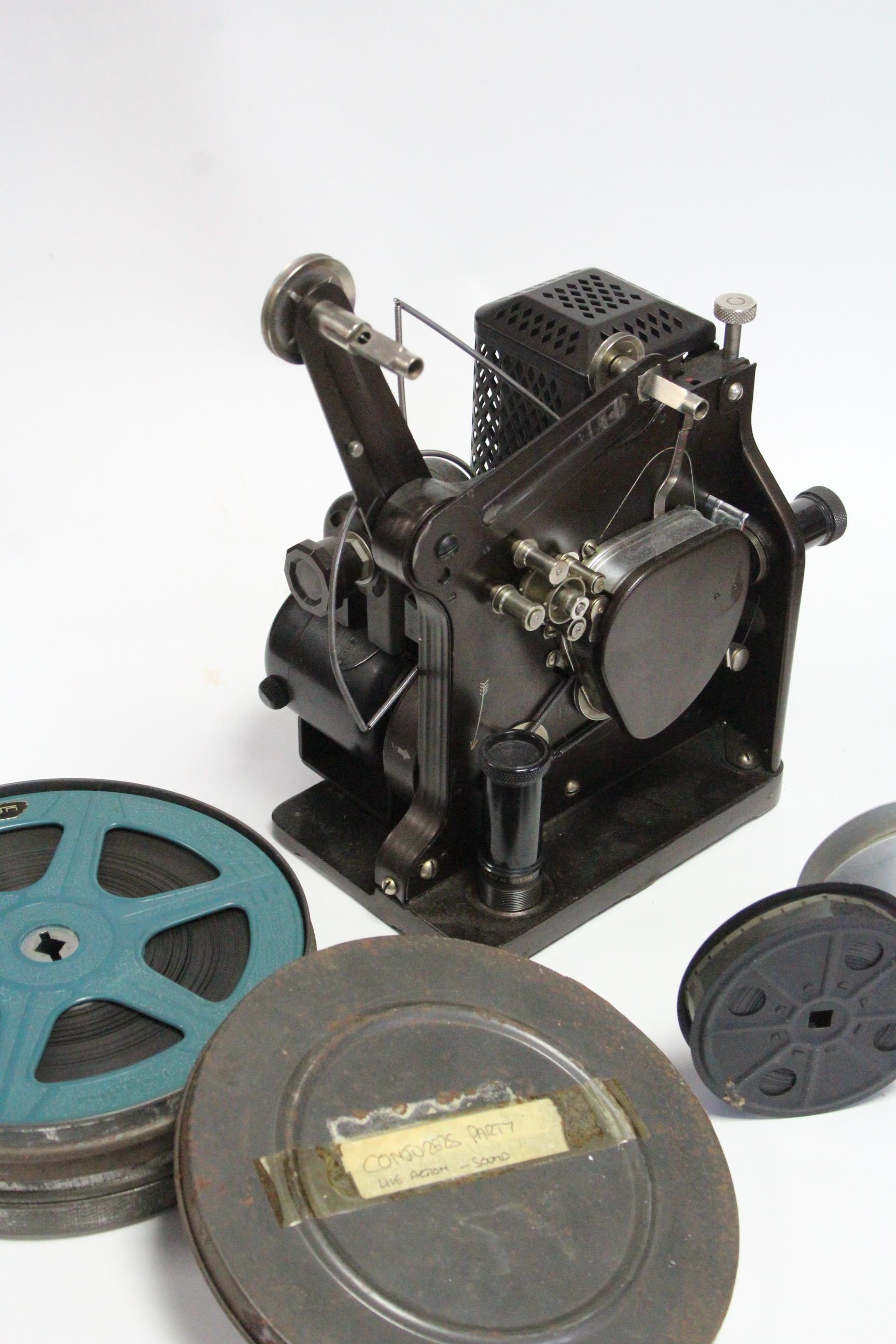 A collection of 16mm film reels; a film projector; & a film editor. - Image 2 of 11