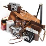 An Agfa Isolette folding camera; together with two other cameras, all cased; & various camera